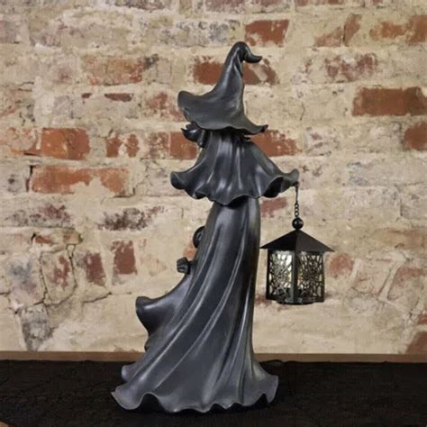 Cracker barrel halloween witch decor featuring a lantern